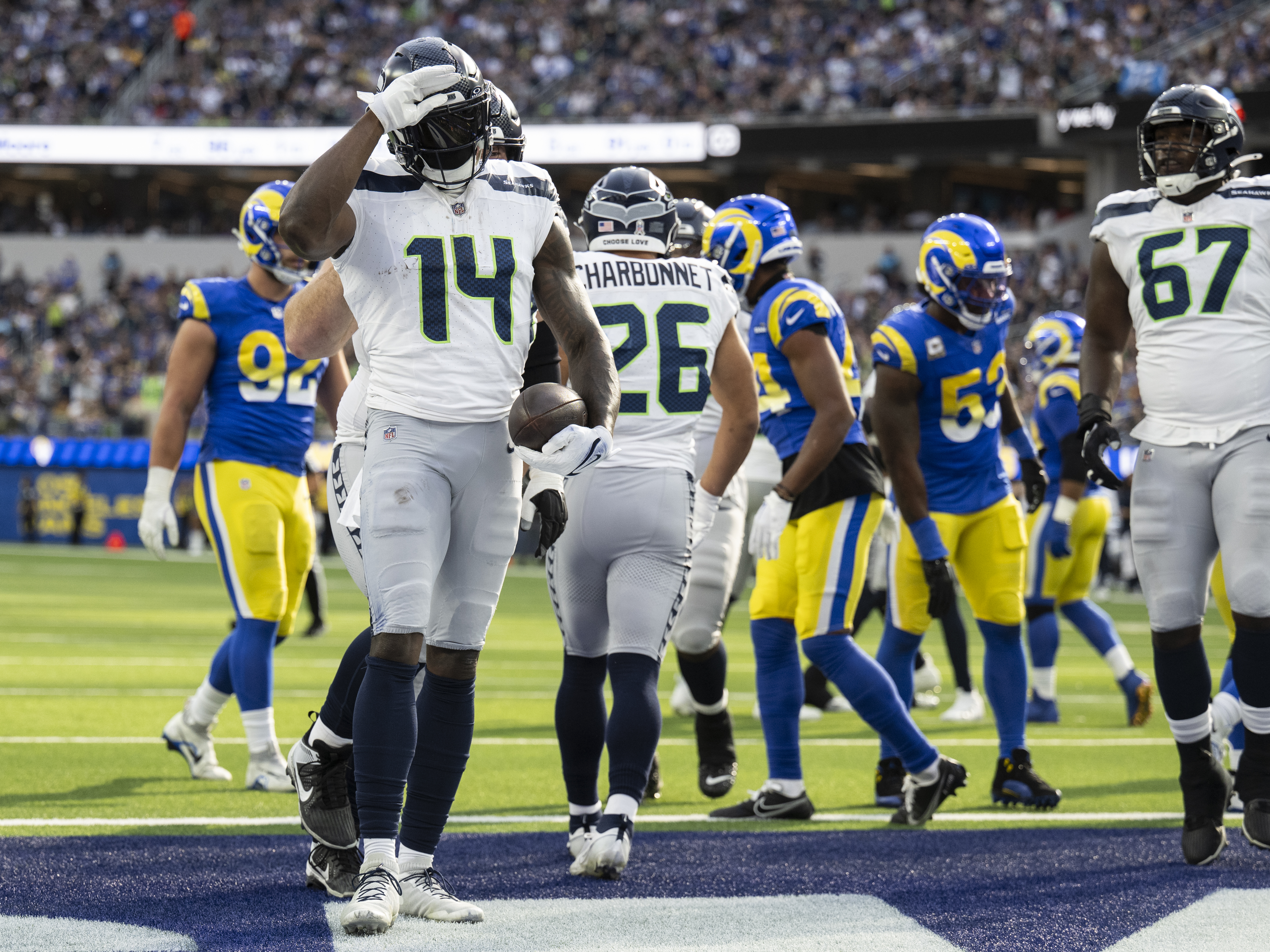 caption: Seattle Seahawks wide receiver DK Metcalf (14) celebrates his touchdown by using American Sign Language during an NFL football game against the Los Angeles Rams, Sunday, Nov. 19, 2023, in Inglewood, Calif.