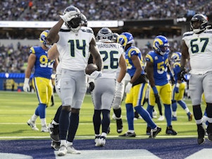 caption: Seattle Seahawks wide receiver DK Metcalf (14) celebrates his touchdown by using American Sign Language during an NFL football game against the Los Angeles Rams, Sunday, Nov. 19, 2023, in Inglewood, Calif.
