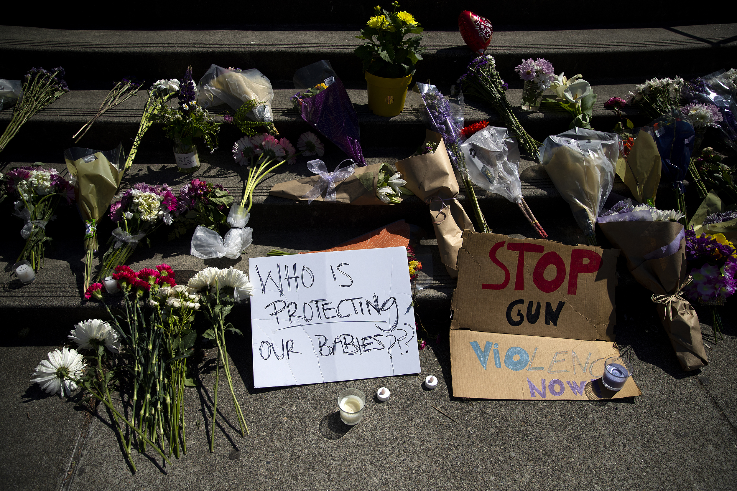 caption: A growing memorial for a 17-year-old student who was shot and killed is shown on Friday, June 7, 2024, at Garfield High School in Seattle. 