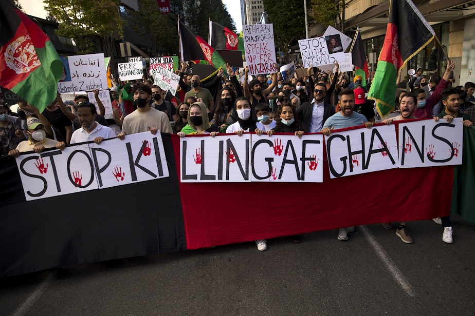 caption: About 100 people attended a rally and march to stand in solidarity with Afghans on Saturday, August 28, 2021, at Westlake Park in Seattle. "What is happening in Afghanistan is devastating," said Shugla Kakar, with Afghans of Seattle. "We're trying to amplify Afghan voices and experiences, and push for urgent action by our federal, state and local leaders to help evacuate those at grave risk in Afghanistan while also supporting the incoming Afghan refugees in our state." 