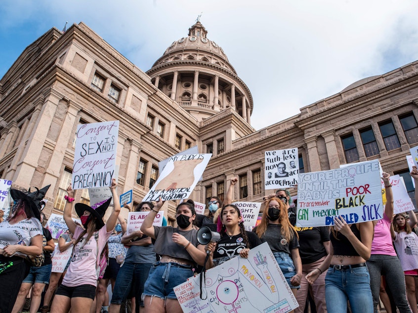 caption: Protesters take part in the Women's March and Rally for Abortion Justice at the State Capitol in Austin, Texas, on Saturday.