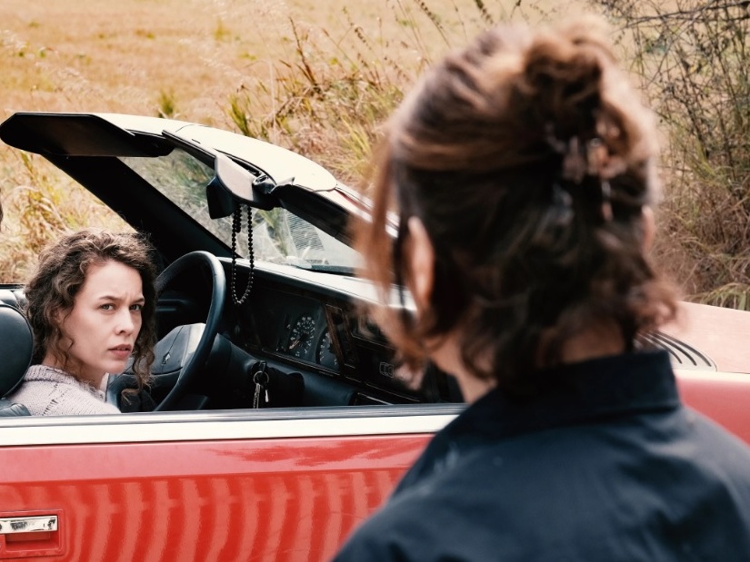 caption: Paula Beer (center) and Barbara Auer (right) in <em>Miroirs No. 3.</em>