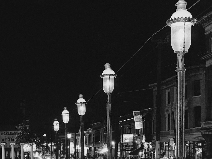 caption: Gas lamps illuminate St. Louis' Gaslight Square on April 2, 1962. "Gaslighting" — mind manipulating, grossly misleading, downright deceitful — is Merriam-Webster's word of 2022.