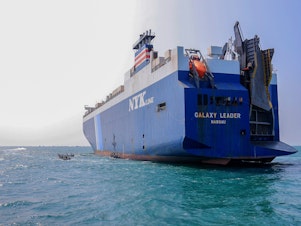 caption: The Galaxy Leader cargo ship was seized by Houthi fighters in the Red Sea in late November. The Bahamas-flagged, British-owned Galaxy Leader, operated by a Japanese firm but having links to an Israeli businessman, was headed from Turkey to India when it was seized and rerouted to the Yemeni port of Hodeida.