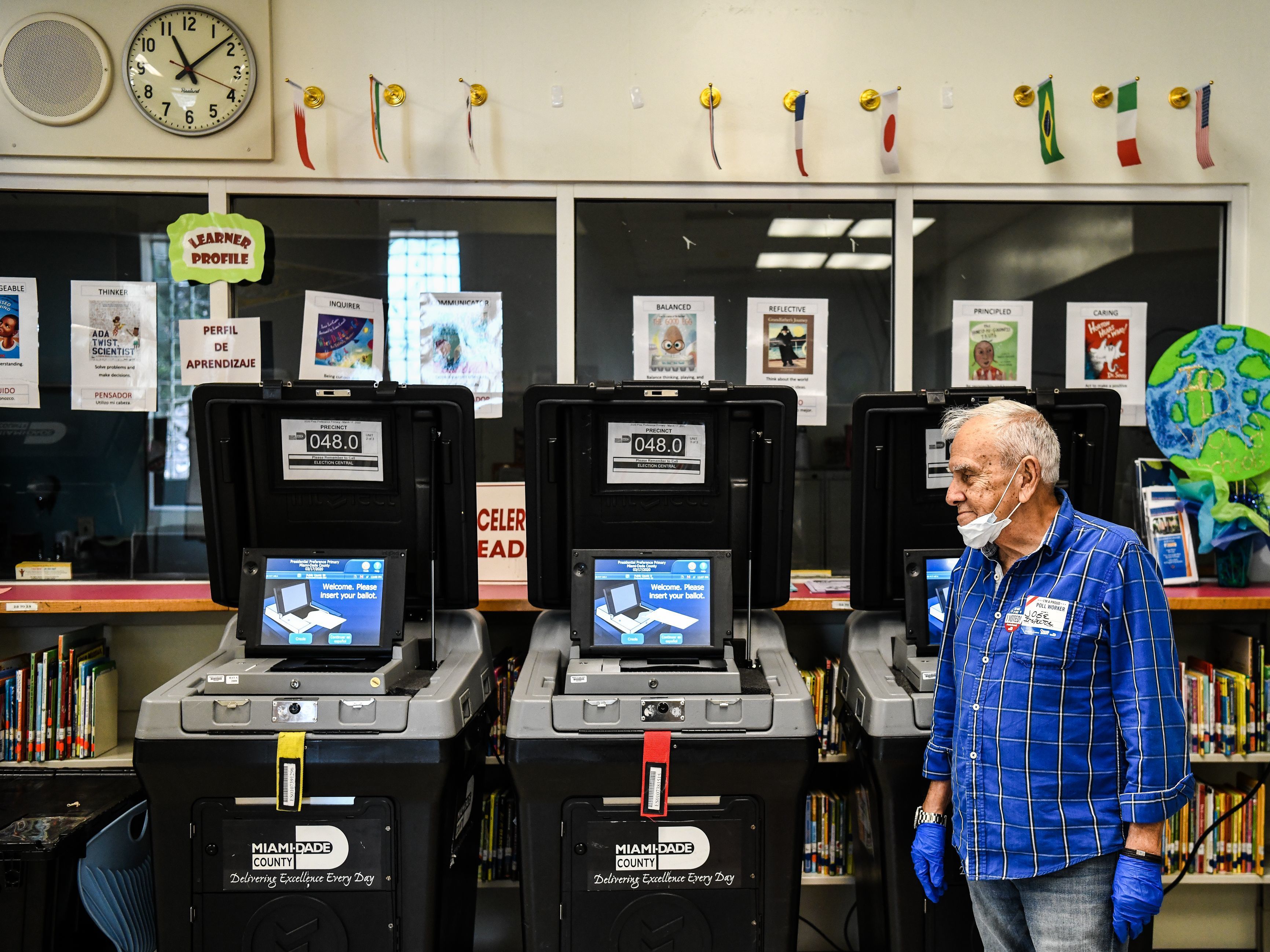 caption: An election worker at a poling station in Miami during last month's election there. The coronavirus pandemic is challenging election officials, whose own staffers are coming sick with the virus.