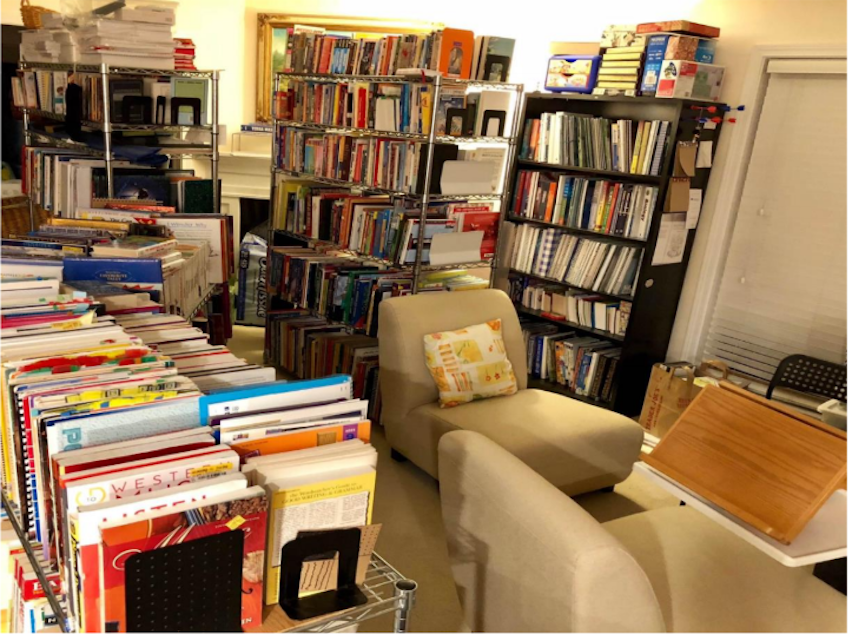 caption: Welcome to the Chuas’ home library. Beware of book-alanches!