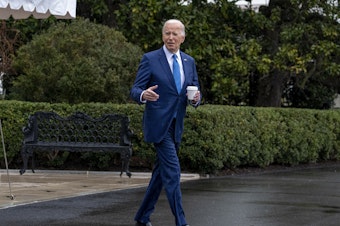 caption: President Biden walks out of the White House on Feb. 28 to board Marine One for a short trip to Walter Reed National Military Medical Center in Bethesda, Md., for his annual physical.