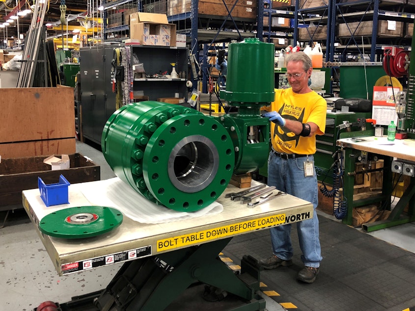 caption: A worker assembles an industrial valve at Emerson Electric Co.'s factory in Marshalltown, Iowa. The manufacturing sector has seen a slowdown amid the ongoing trade war.