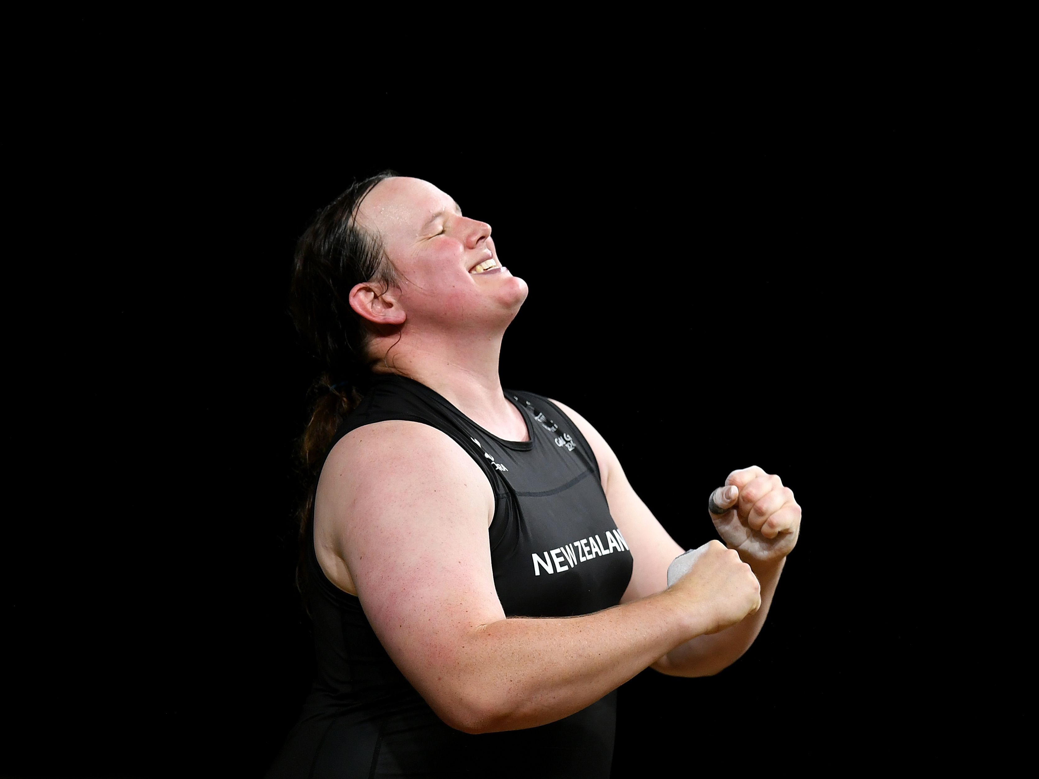 caption: New Zealand weightlifter Laurel Hubbard celebrates completing a lift at the 2018 Commonwealth Games in Australia. Hubbard has been named to New Zealand's team at the Tokyo Olympics, making her the first openly transgender competitor at the Olympics.