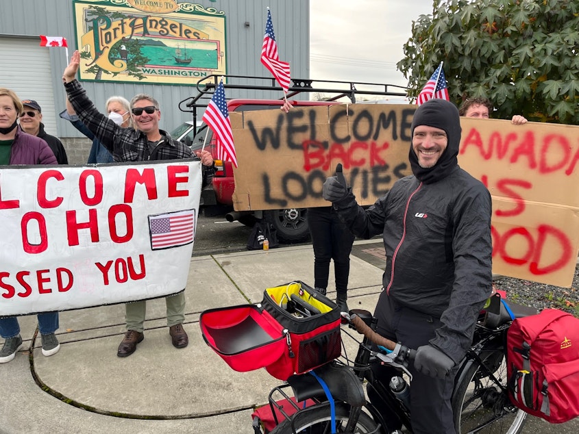 caption: Quebecois long-distance cyclist Jean-Francois Bienvenue soaked in the warm welcome Monday in Port Angeles, having previously waited in a holding pattern in British Columbia until the border opened. 
