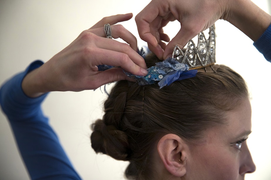 caption: Soloist Leah Merchant puts on a crown while getting ready to perform in Cinderella in her dressing room on Saturday, February 1, 2020, at McCaw Hall in Seattle.