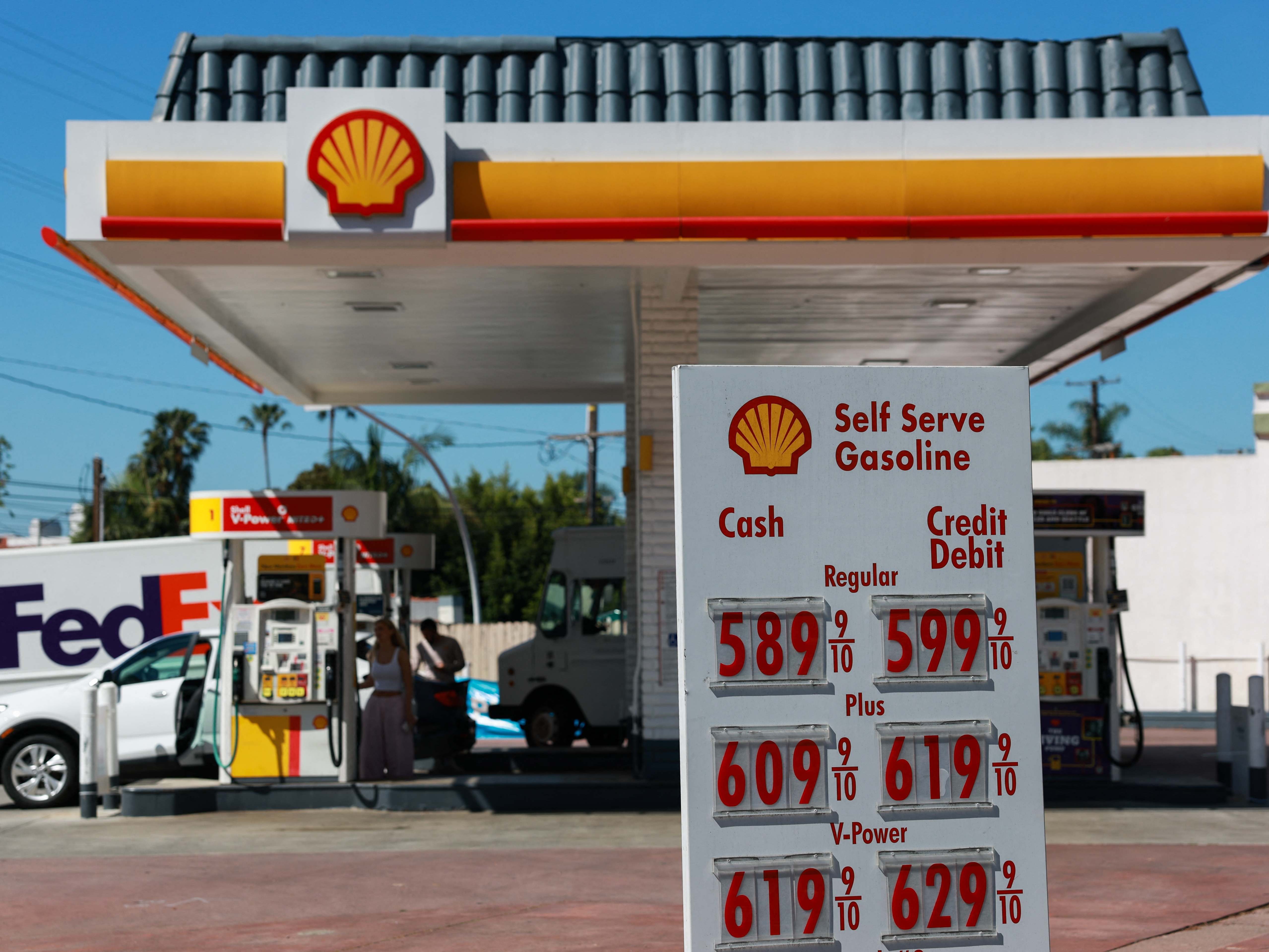 caption: Gasoline prices are displayed outside of a Shell gas station in West Hollywood, California on April 14. Prices vary around the country, and are highest on the west coast; the nationwide average has risen by more than $1 per gallon since the start of the Iran War, but is expected to drop if a decrease in crude oil prices is sustained.