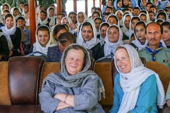 caption: Marnie Gustavson, front left, with her sister Frances Nunes and Afghan scouts at a school presentation prior to the Taliban takeover. 
