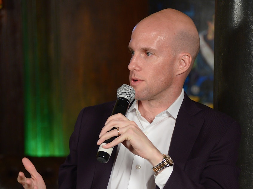caption: In this file photo, sportswriter Grant Wahl speaks during a panel discussion in New York in 2014. He died Friday in Qatar while covering the Argentina-Netherlands World Cup quarterfinal.