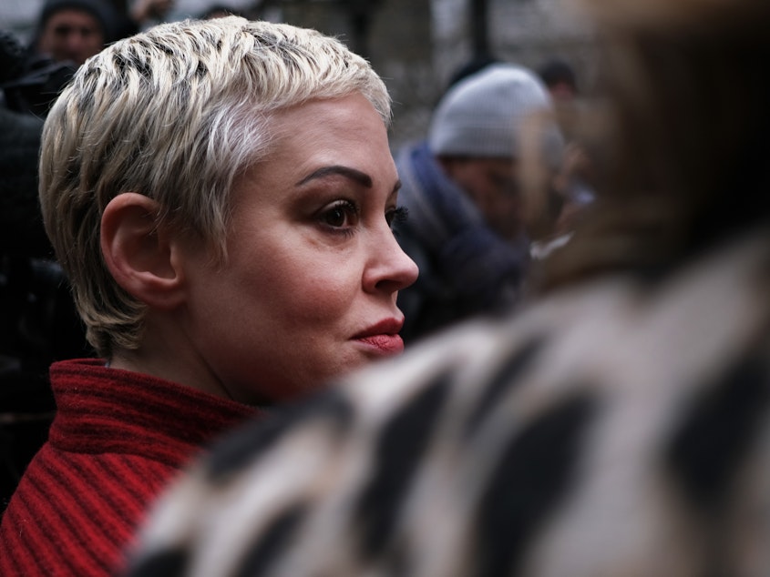 caption: Actor Rose McGowan, who accused Weinstein of raping her more two two decades ago and then of destroying her career, joins other accusers and protesters as Harvey Weinstein arrives at a Manhattan court house for the start of his January 2020 trial in New York City.