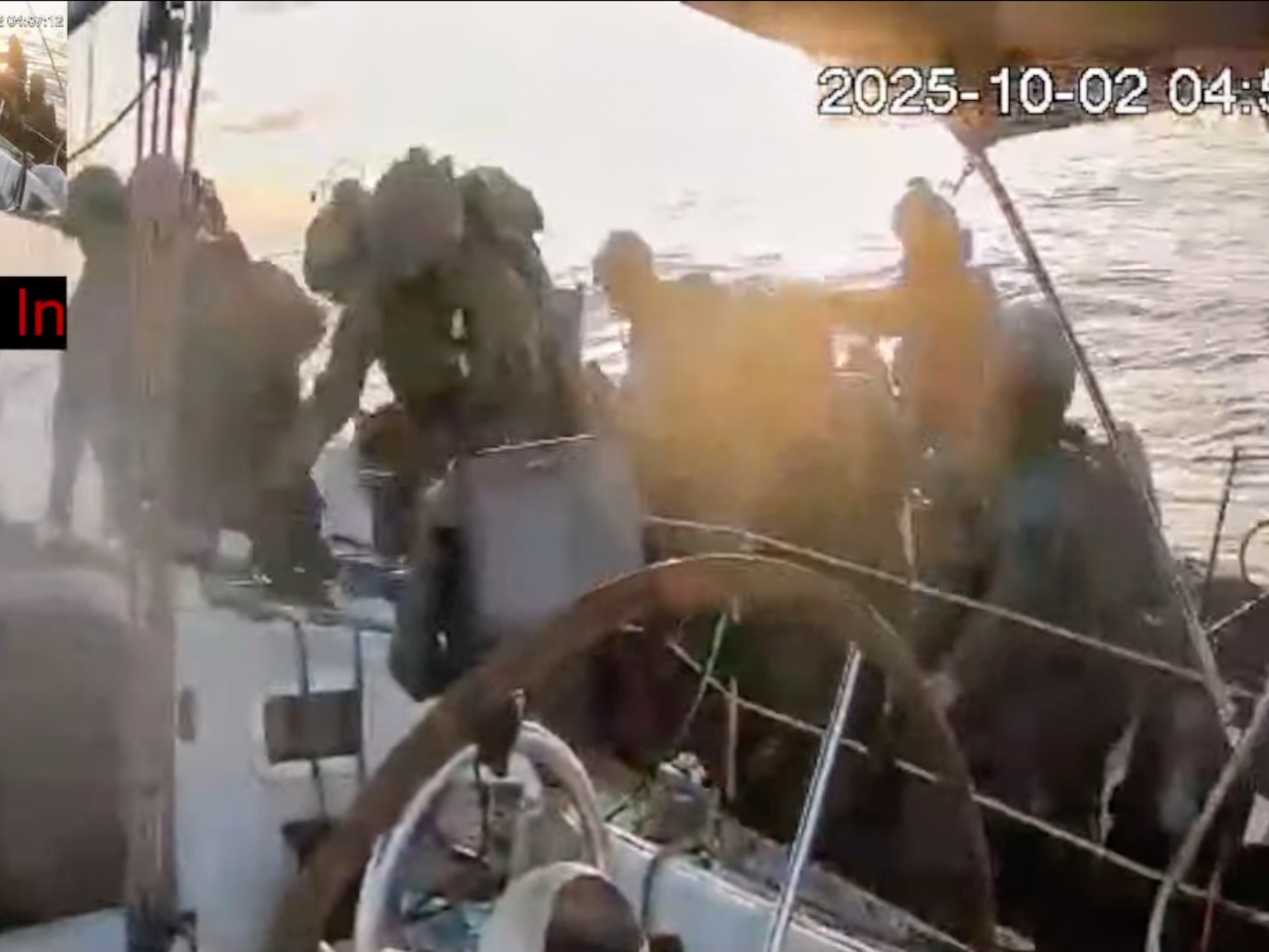 caption: This frame grab from video released by the Global Sumud Flotilla shows Israeli navy soldiers boarding one of the flotilla's vessels as it approached the coast of Gaza early Thursday.