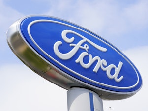 caption: A Ford sign is shown at a dealership in Springfield, Pa., in 2022. Ford is recalling nearly 243,000 Maverick small pickup trucks in the U.S. because the tail lights may not illuminate.