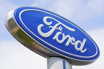 caption: A Ford sign is shown at a dealership in Springfield, Pa., in 2022. Ford is recalling nearly 243,000 Maverick small pickup trucks in the U.S. because the tail lights may not illuminate.