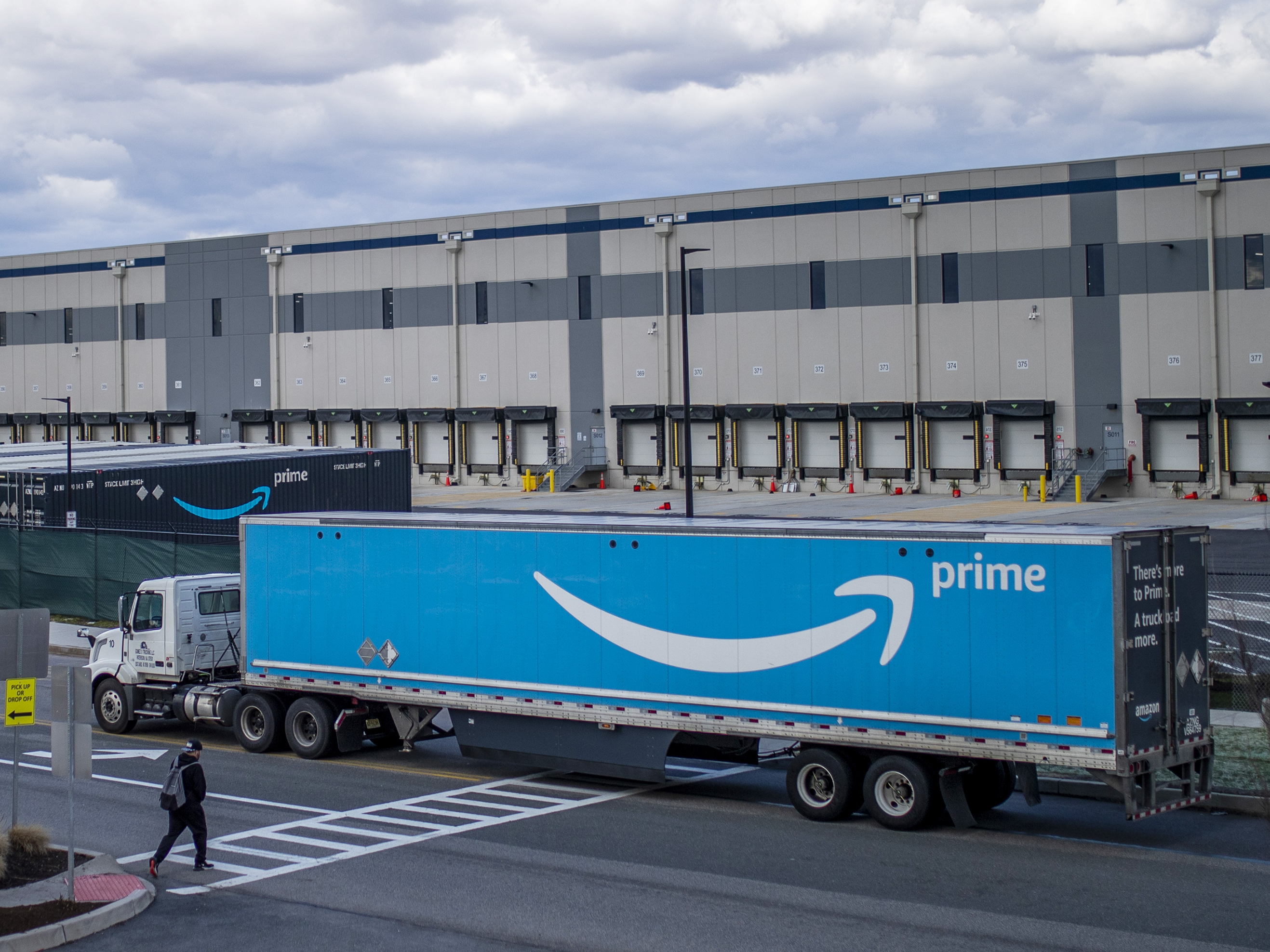 caption: A truck arrives at the Amazon warehouse in Staten Island, N.Y., which became the company's first unionized U.S. facility in the spring.