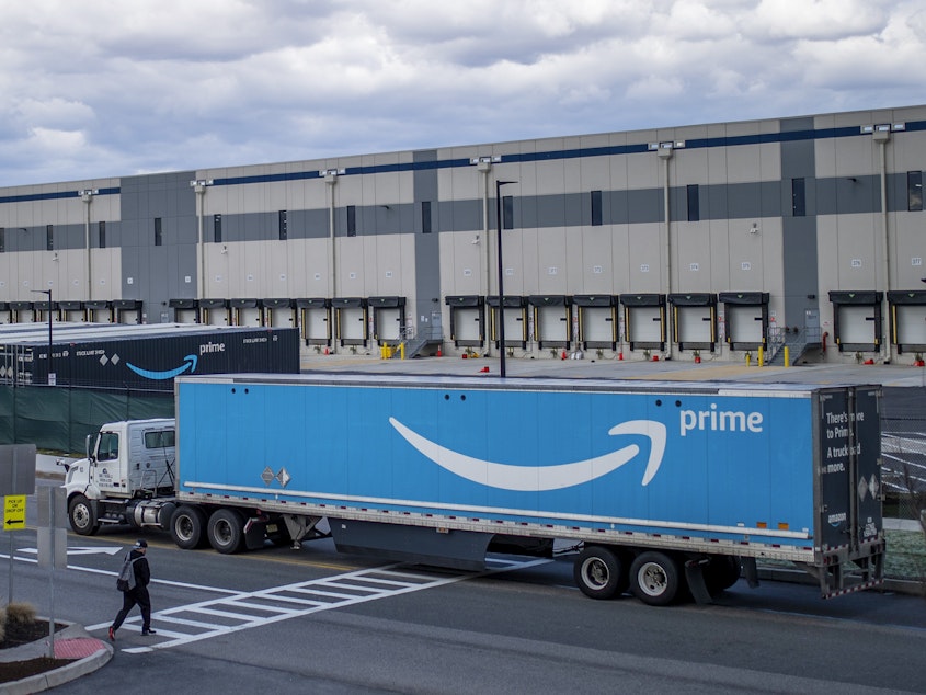 caption: A truck arrives at the Amazon warehouse in Staten Island, N.Y., which became the company's first unionized U.S. facility in the spring.