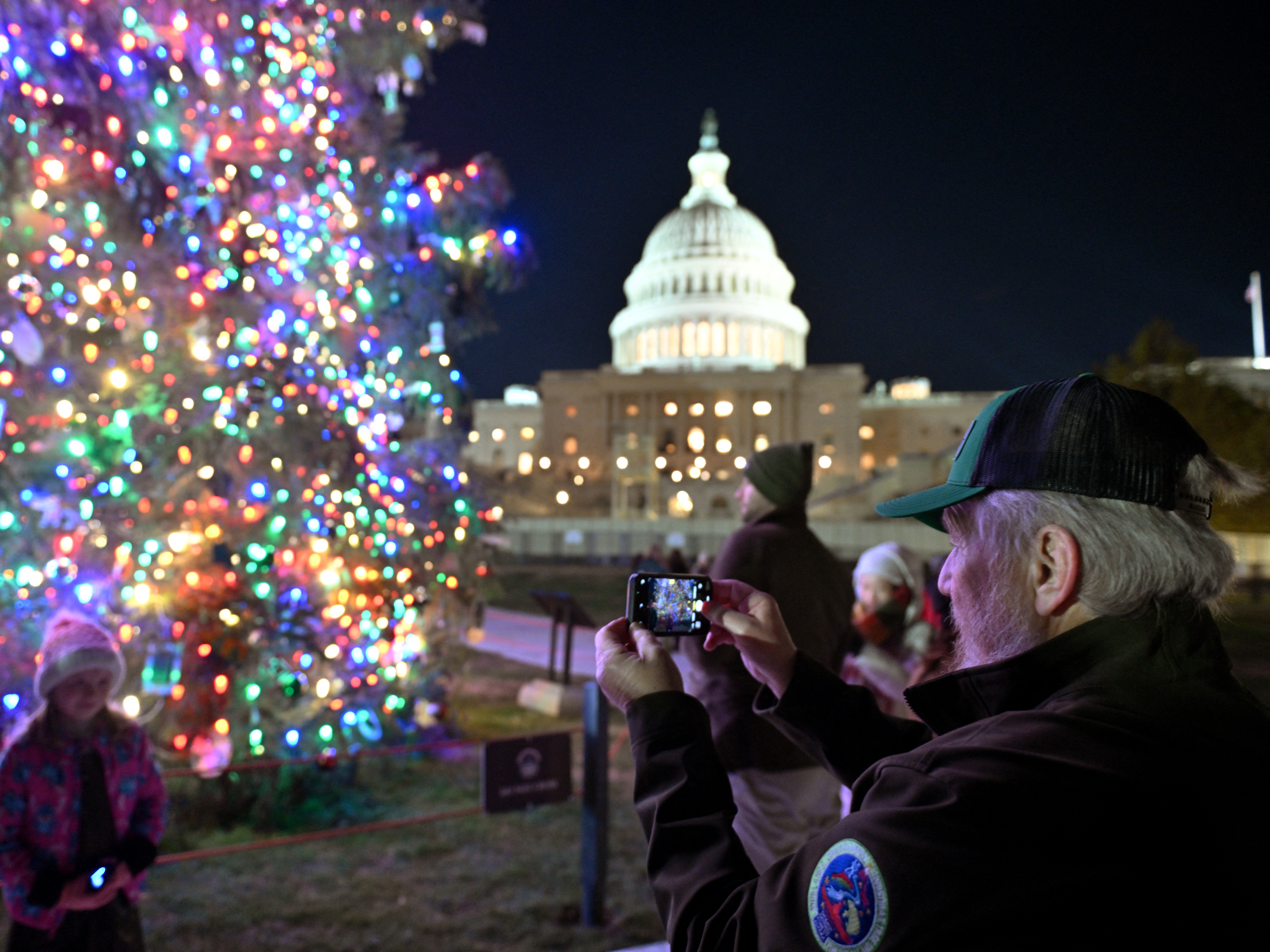 caption: The Christmas tree outside the U.S. Capitol is illuminated as Congress works to finalize a stop-gap spending bill to avoid a government shutdown.