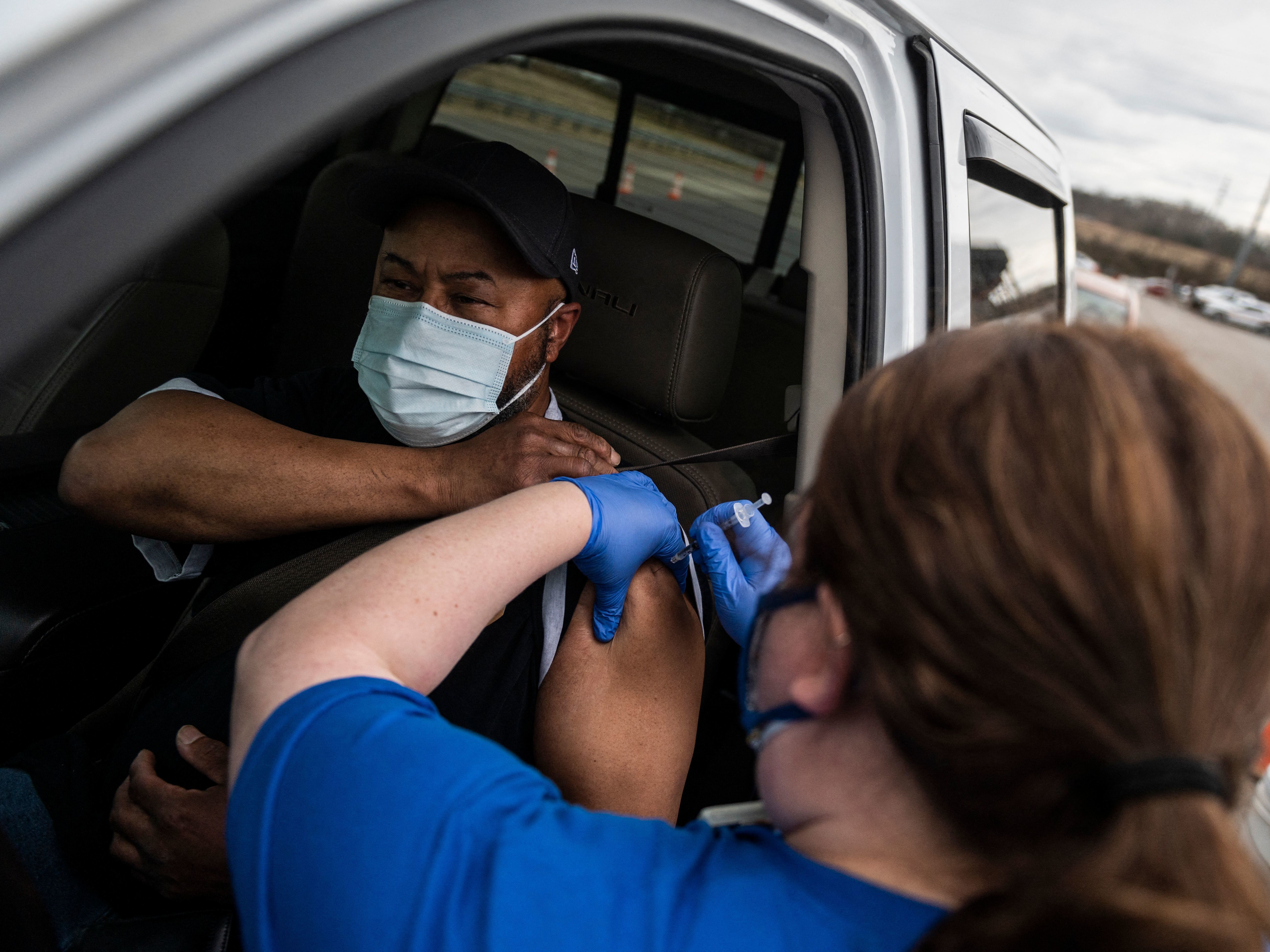 caption: A nurse administers a shot at a COVID-19 mass vaccination site at Martinsville speedway in Ridgeway, Va., on March 12. Ashish Jha, a public health policy researcher, noted Sunday that &quot;despite phenomenal vaccination rates, variants pulled ahead this week.&quot;