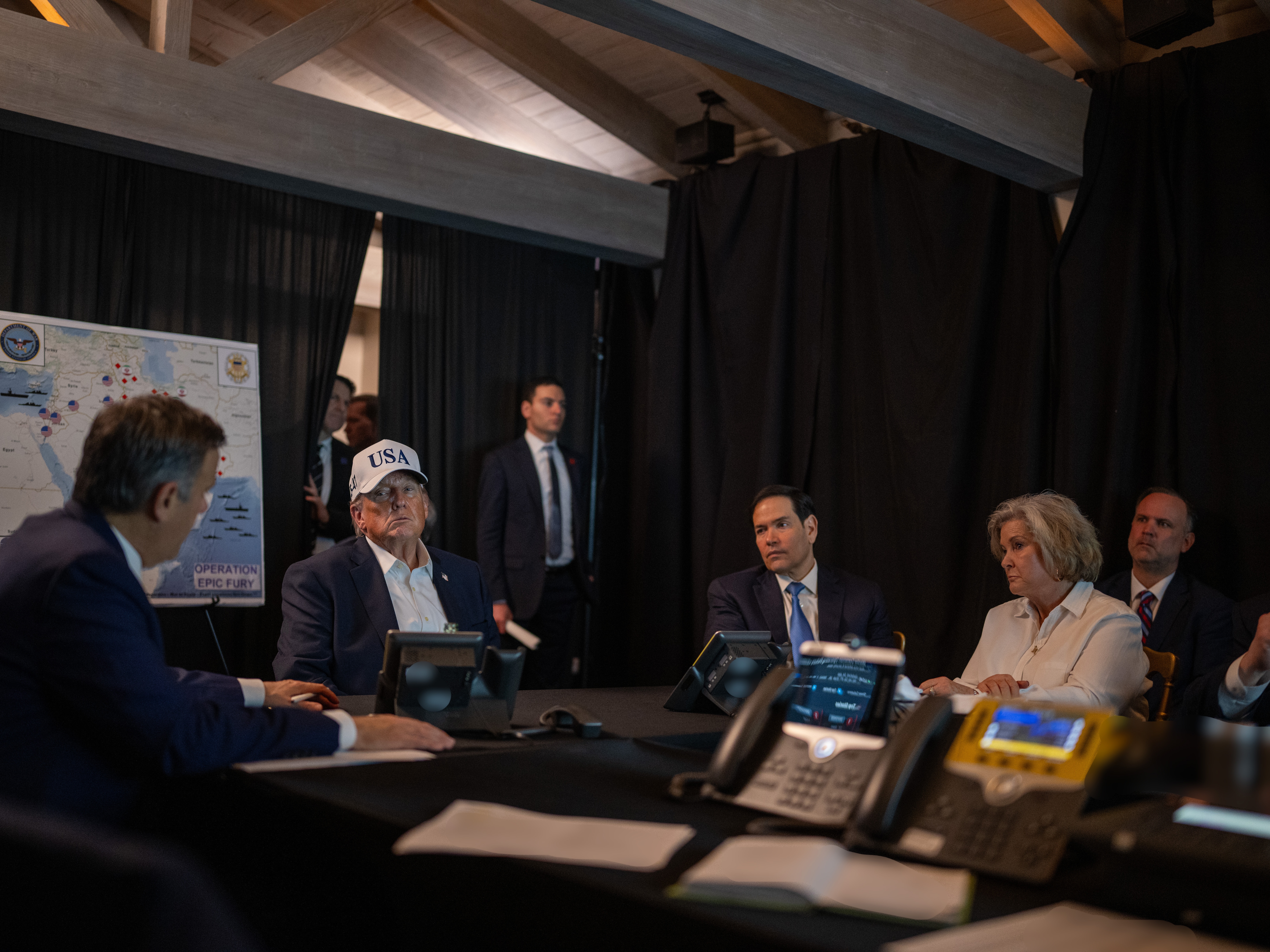 caption: U.S. President Donald Trump (C) oversees "Operation Epic Fury" with (L-R) Central Intelligence Agency Director John Ratcliffe, U.S. Secretary of State Marco Rubio and White House Chief of Staff Susie Wiles at Mar-a-Lago on February 28, 2026 in Palm Beach, Florida.
