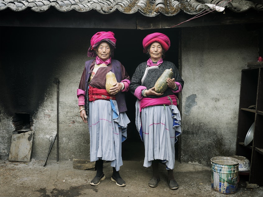 caption: Naju Dorma, 73, and Lacuo Dorma, 66, belong to the Mosuo society in China, where grandmothers head up households. They're posing in traditional garb in their village of Luoshui.