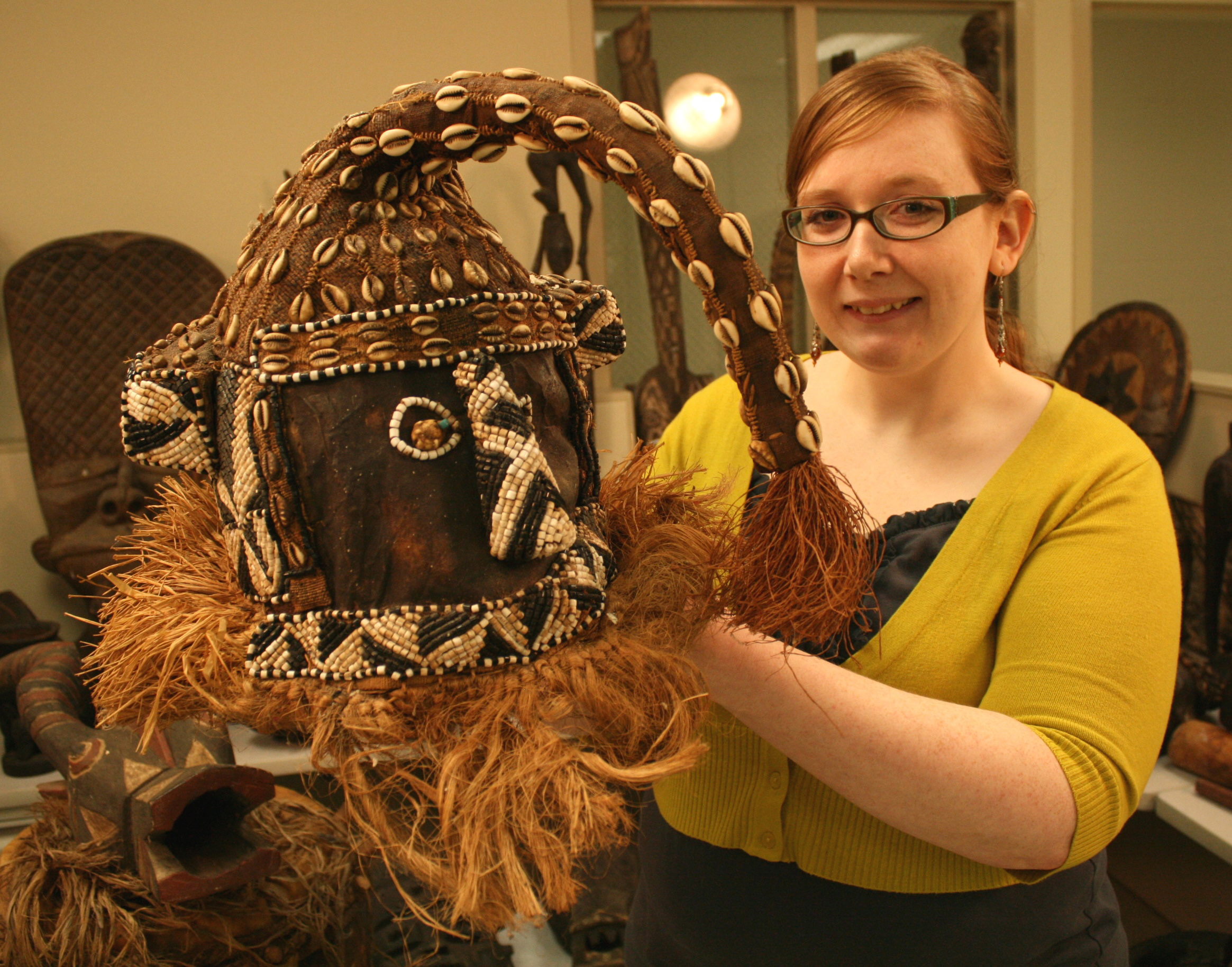 caption: Jazlan Grigsby, the online appraiser, holds up a Kuba Artifact.