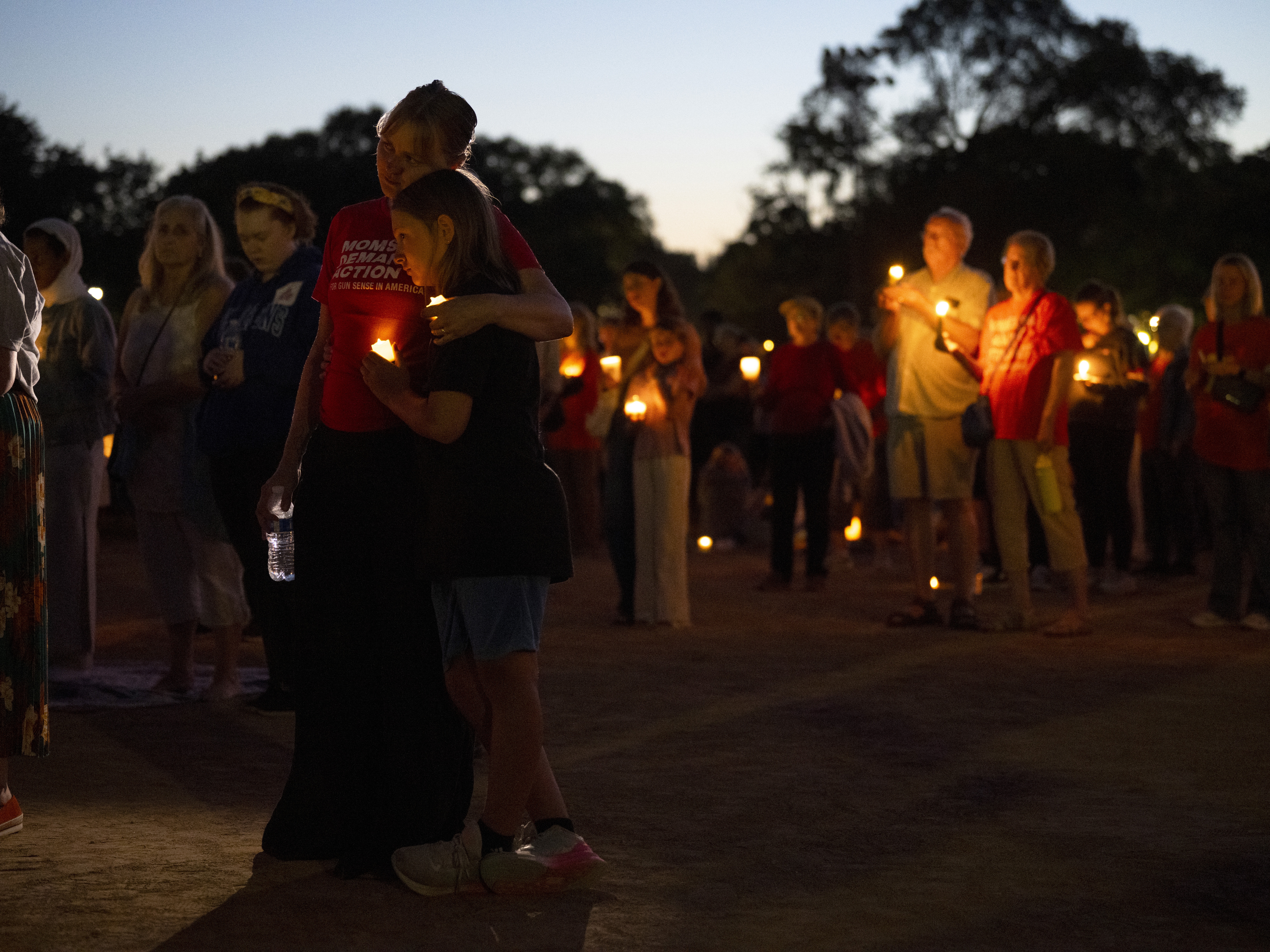 caption: People attend a vigil following a mass shooting at Annunciation Catholic School on August 27, 2025 in Minneapolis, Minnesota.