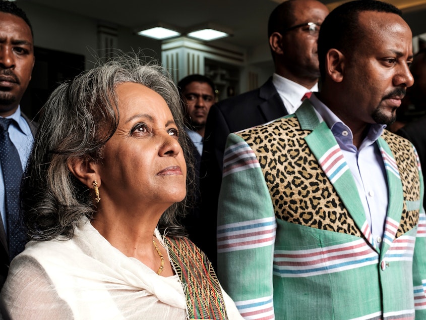 caption: Sahle-Work Zewde walks with Prime Minister Abiy Ahmed after being appointed Ethiopia's first female president at the country's parliament in Addis Ababa on Thursday.