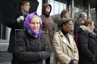 caption: About 20 people stood vigil to mark two recent deaths at a homeless camp in Seattle.