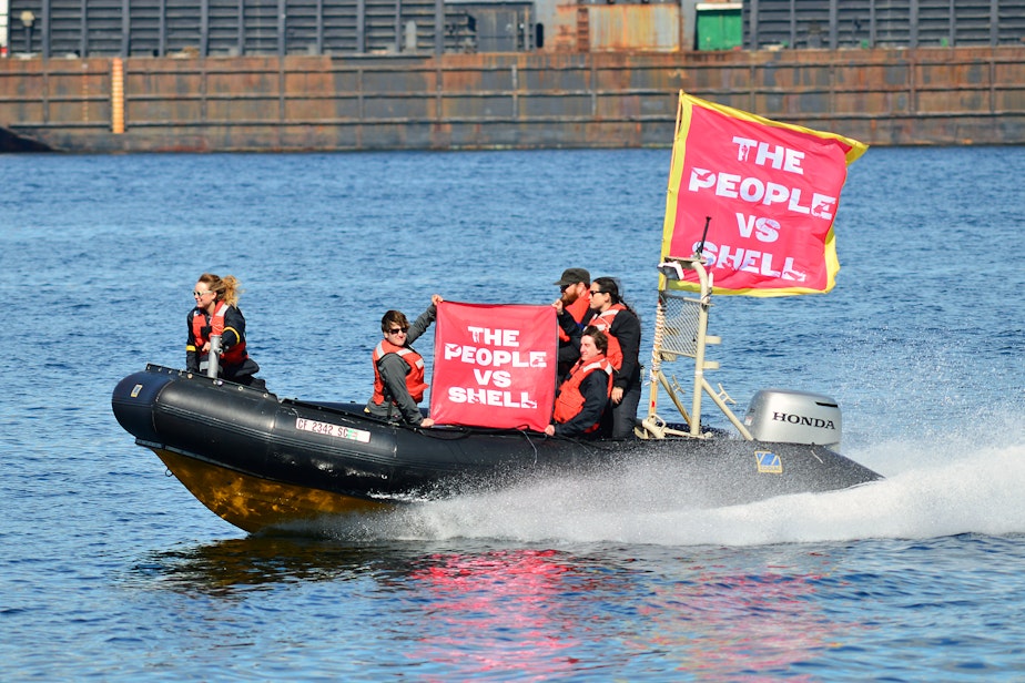 caption: Protesters buzz along the West Seattle shore as the Polar Pioneer is hauled toward the Port of Seattle's Terminal 5 on Thursday, March 14, 2015.