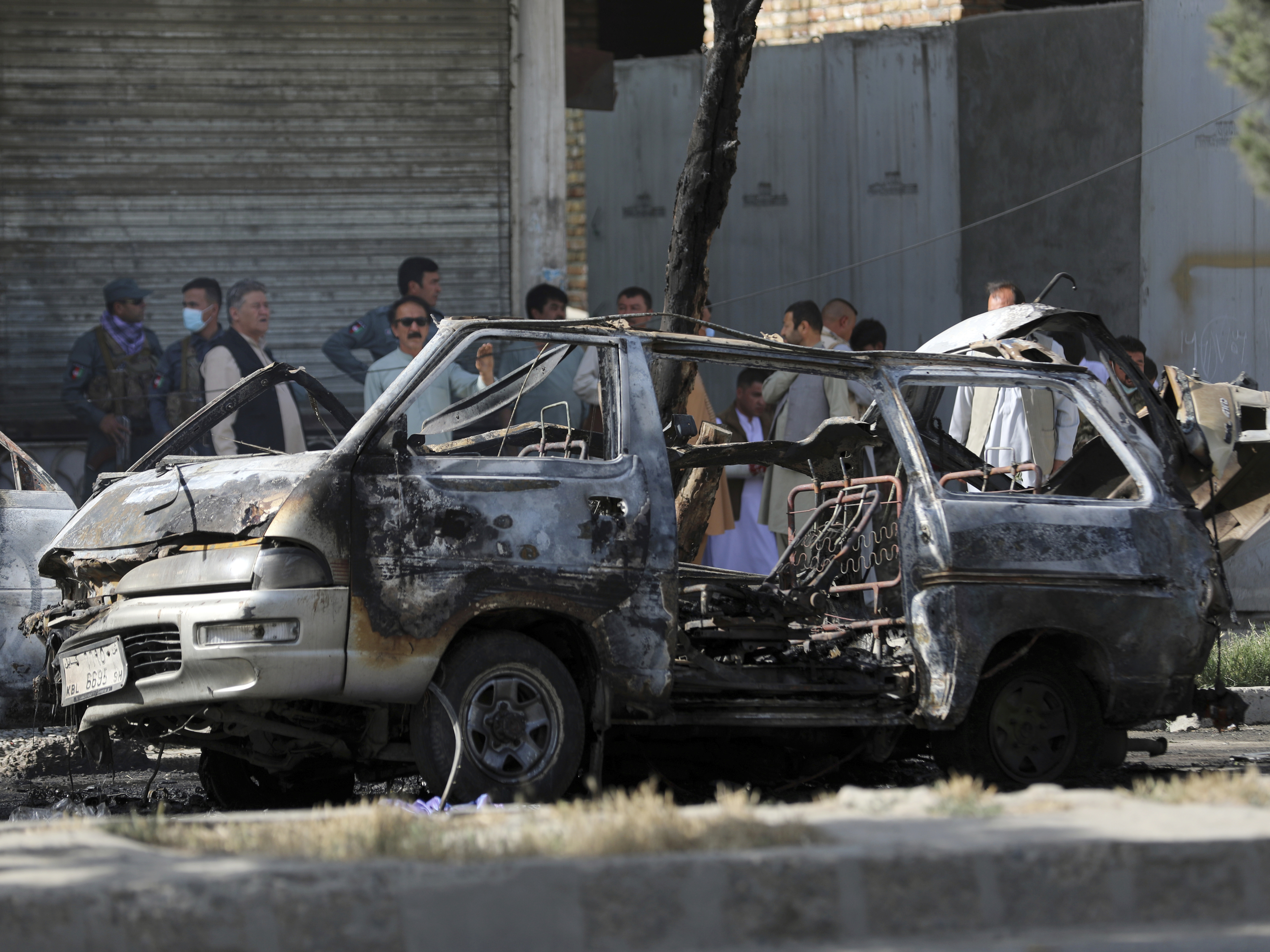 caption: In this June 12, 2021 photo, Afghan security personnel inspect the site of a bomb explosion in Kabul, Afghanistan. In a report released Monday, the United Nations said that more women and children were killed and wounded in Afghanistan in the first half of 2021 than in any year since the UN began keeping count.