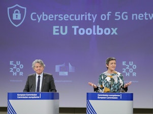 caption: Two European Commission officials, Thierry Breton (left) and Margrethe Vestager (right), give a press conference on 5G security Wednesday in Brussels. The EU recommended that member states screen telecom firms, but did not call for banning any by name. The Chinese telecom Huawei said it welcomed the decision and hopes to take part in building 5G networks in Europe.