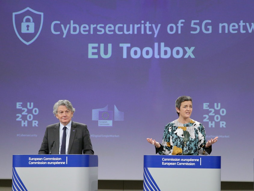 caption: Two European Commission officials, Thierry Breton (left) and Margrethe Vestager (right), give a press conference on 5G security Wednesday in Brussels. The EU recommended that member states screen telecom firms, but did not call for banning any by name. The Chinese telecom Huawei said it welcomed the decision and hopes to take part in building 5G networks in Europe.