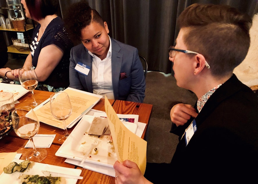 caption: Mellina White Cusack (left) listens while in-conversation with fellow Queeriosity Club member Keri Zierler at The Cloud Room in Seattle. June 6, 2019