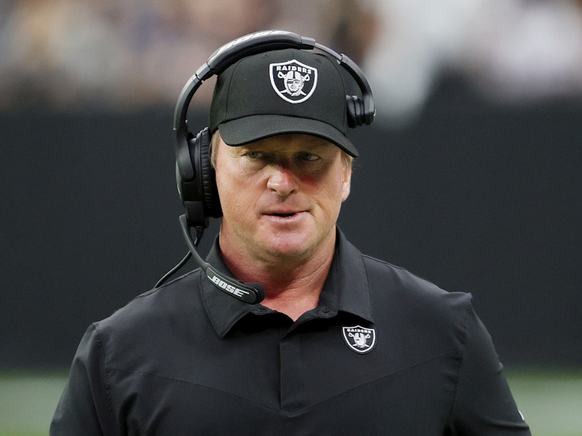 caption: Jon Gruden resigned as coach of the Las Vegas Raiders on Monday night following reports he had sent derogatory and offensive emails. Gruden is seen here on the sidelines against the Chicago Bears on Sunday in Las Vegas, Nev.