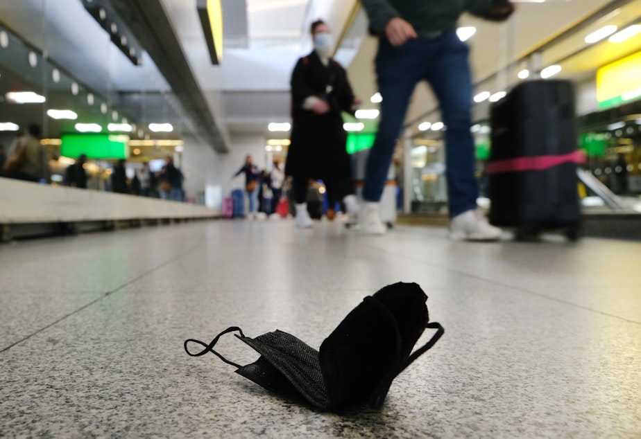caption: A mask lies on the ground at John F. Kennedy International Airport in New York City on April 19.