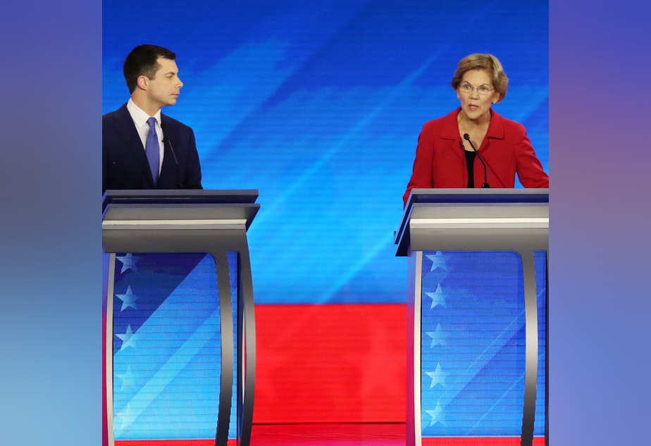 caption: Amy Klobuchar and Michael Bloomberg join these four candidates — Pete Buttigieg (left), Elizabeth Warren, Joe Biden and Bernie Sanders — onstage Wednesday night.