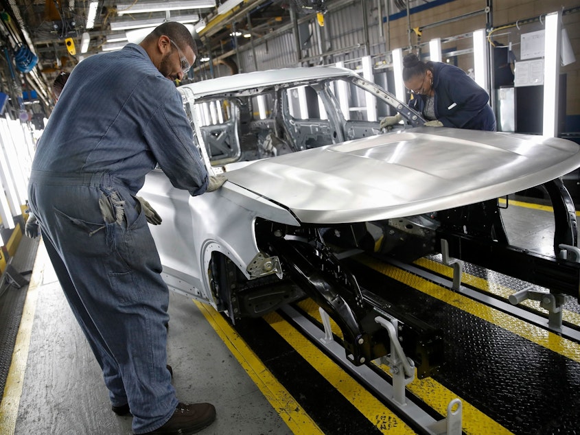 caption: Workers assemble cars at Ford's newly renovated assembly plant in Chicago. Factories lost 12,000 jobs in December. The manufacturing sector has been hard hit by the trade war as well as slowing demand overseas.