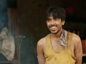 He is "the white tiger" — a poor villager, Balram, portrayed by actor Adarsh Gourav, who is determined to use his intelligence to escape a life of poverty.