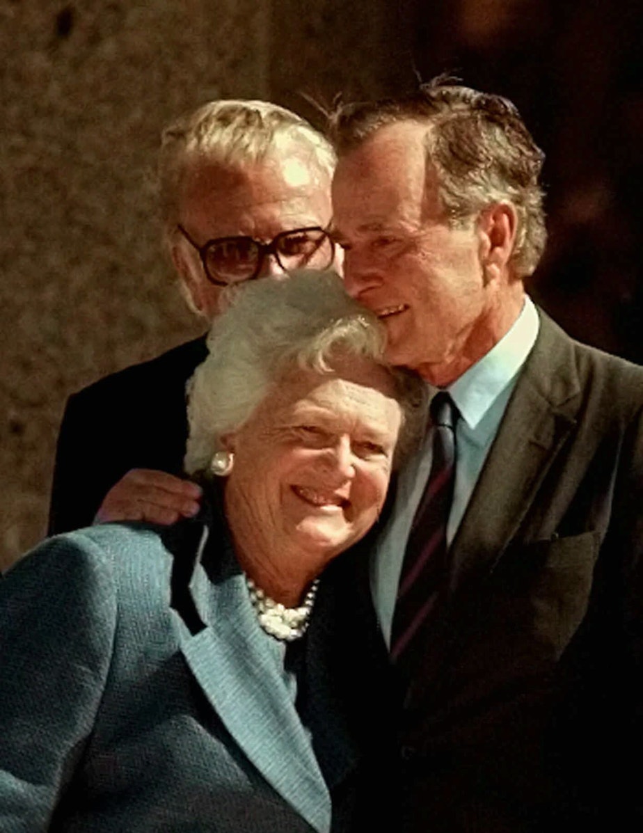caption: In this Nov. 6, 1997, file photo, former President George H.W. Bush hugs his wife, Barbara, after speaking at the dedication of the George Bush Presidential Library in College Station, Texas. The Bushes, married on Jan. 6, 1945, were married for 70 years. 