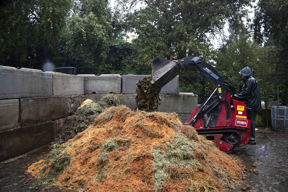 caption: Waste from various animals, including rhinoceros (being added here), is shown while being composted in the 'doo yard' at the Woodland Park Zoo on Wednesday, September 27, 2023, in Seattle. 