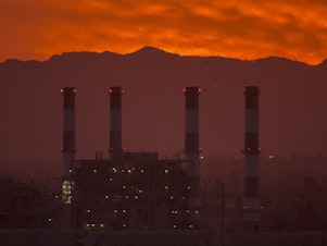 caption: To avoid some of the worst impacts of climate change, greenhouse gas emissions need to be eliminated or offset by midcentury, according to the United Nations. To get there, activist investors say banks and insurance companies need to account for the emissions they contribute to by underwriting and investing in fossil fuel infrastructure like this natural gas plant in California.