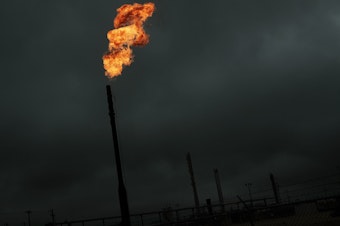 caption: Flared natural gas is burned off at a natural gas plant. Methane, the main ingredient in natural gas, can leak from natural gas plants and pipelines.