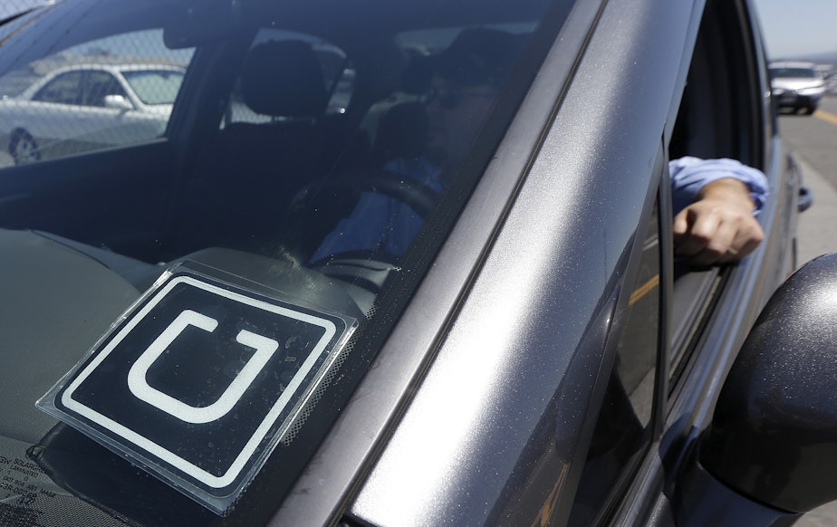 caption: File photo of Uber driver at near the San Francisco International Airport.