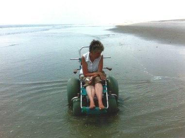 caption: Stephanie Rinka in her beach wheelchair at Fort Fisher State Recreation Area, North Carolina.