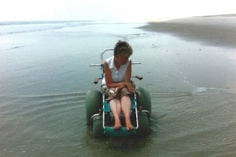 caption: Stephanie Rinka in her beach wheelchair at Fort Fisher State Recreation Area, North Carolina.