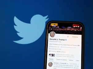 caption: A photo illustration shows the reactivated Twitter profile of former US President Donald Trump. Elon Musk reinstated him on the social media platform on November 19, 2022.